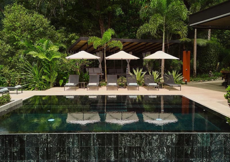 Dossier Man 2025, Costa Rica, swimming pool with lounge chairs among tropical planting