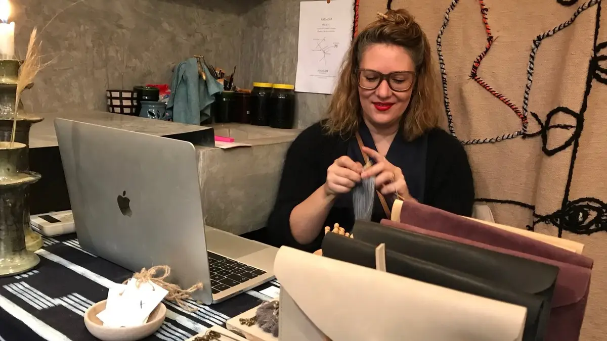 Owner, Carla, busy knitting in her shop.