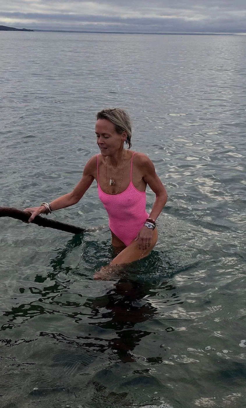 Swimming in the sea in a pink swimsuit