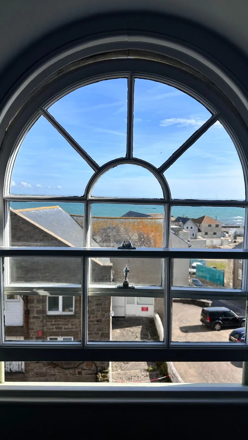 Arched window in Room 4 on a sunny morning