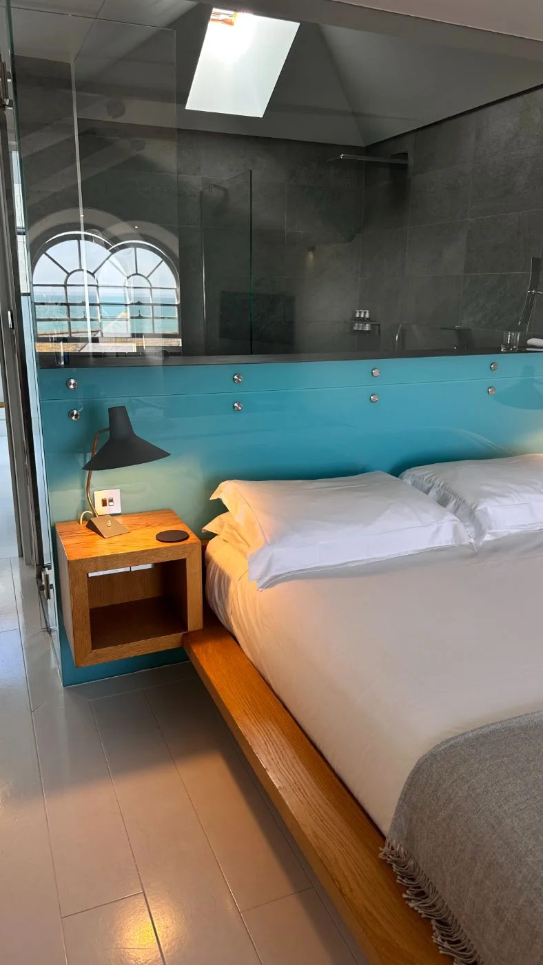 The bed in Room 4 with its turquoise headboard