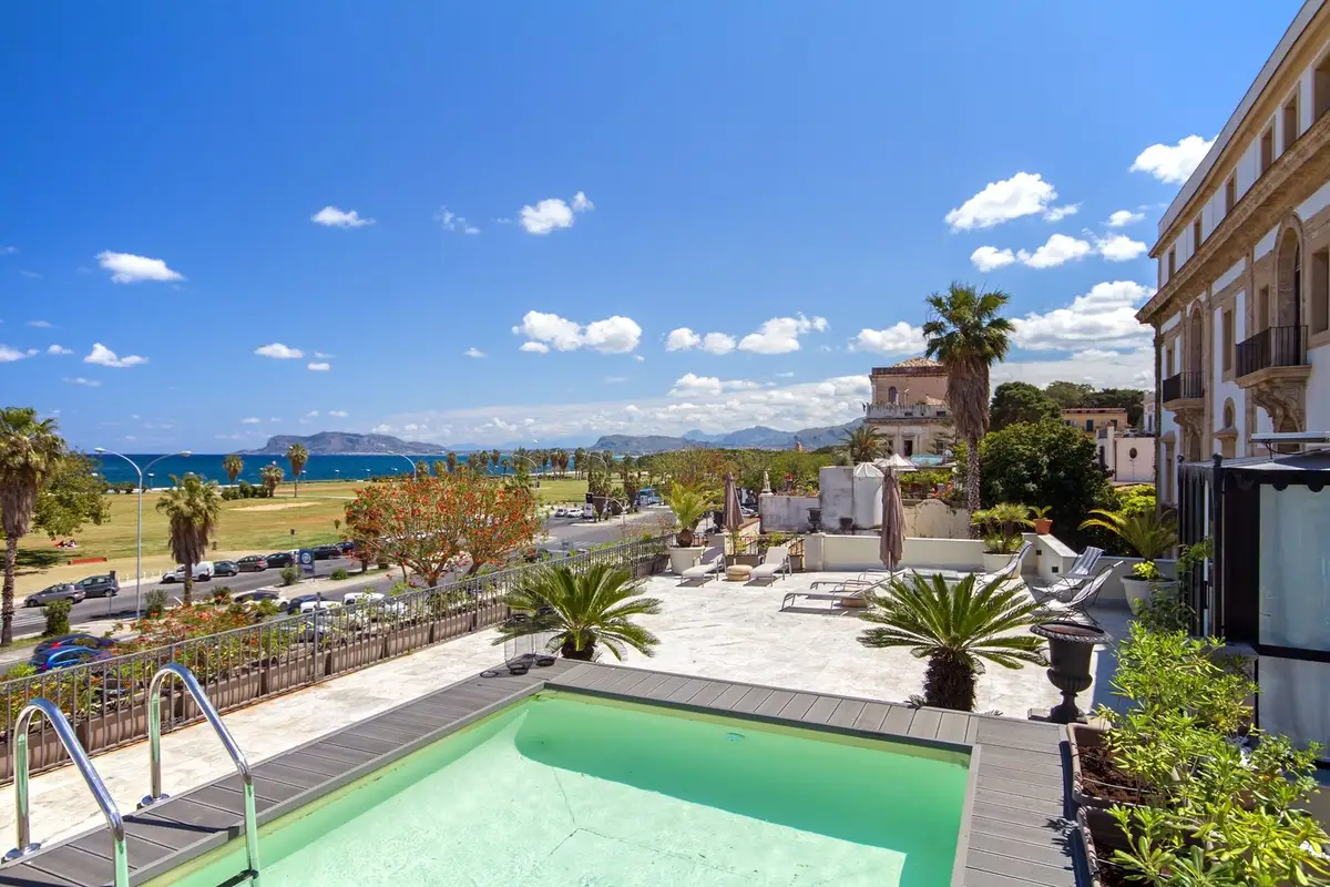 Pool and view at boutique hotel L'Hotellerie Easy Suites in Palermo.